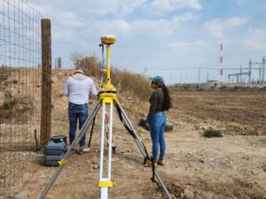 Licensed land surveyor using GPS equipment to review a property boundary before a lot line adjustment in Miramar, Florida